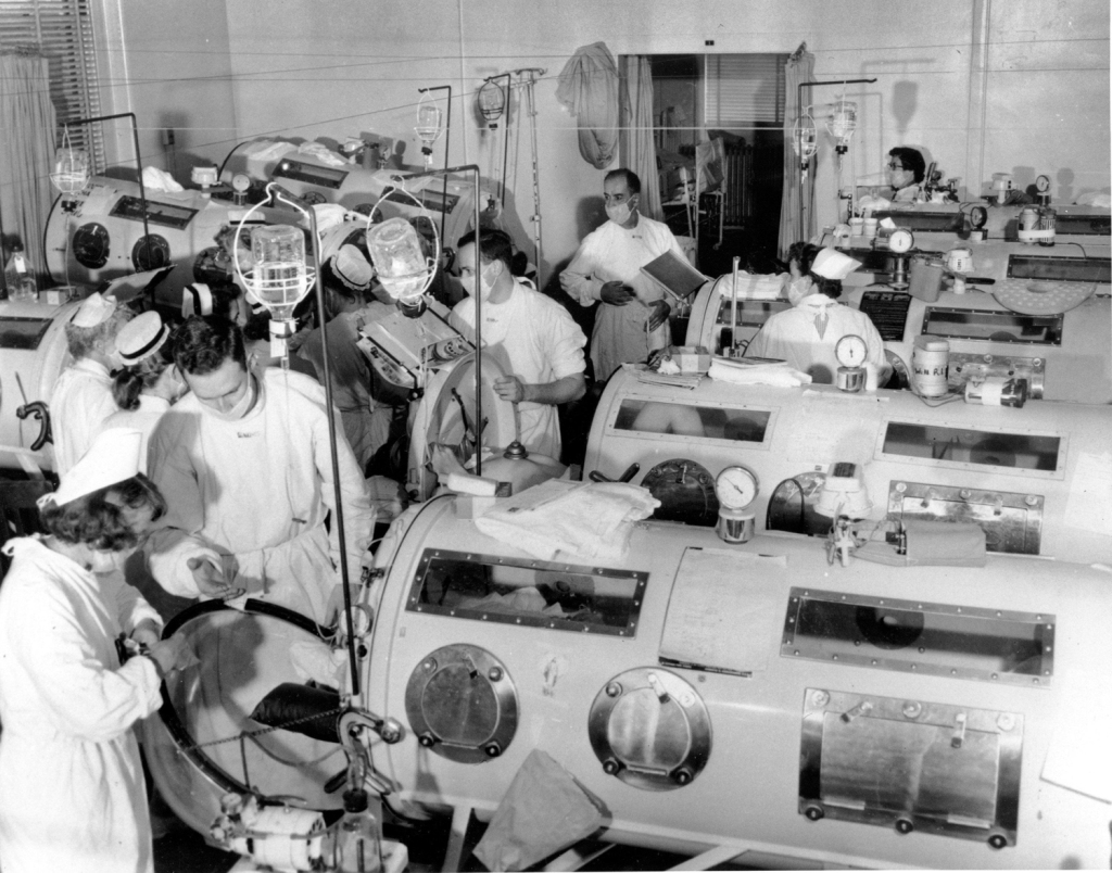 polio patients lined up inside iron lungs